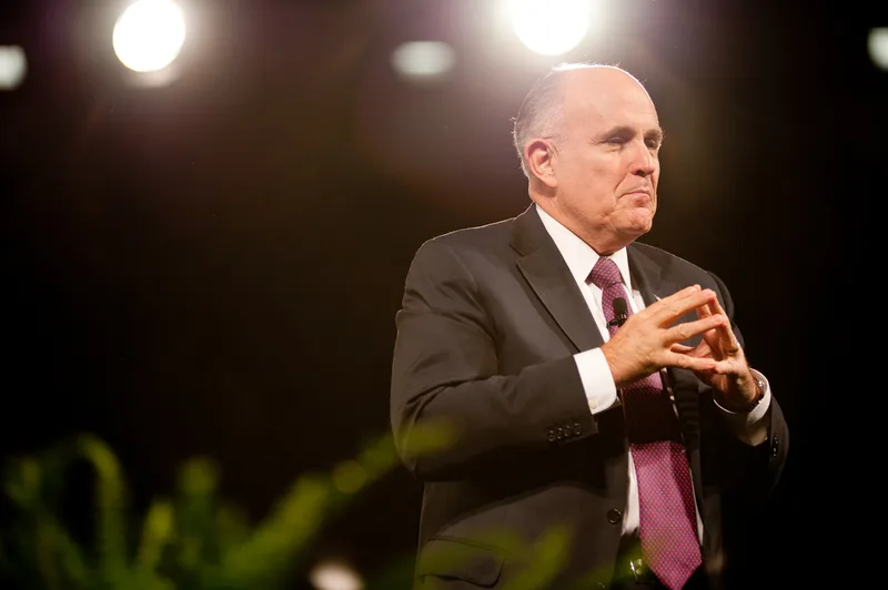 Rudy Giuliani speaking into a microphone