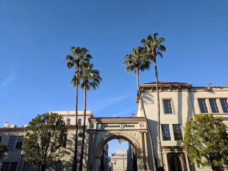 A studio backlot street of facades standing empty under a clear sky